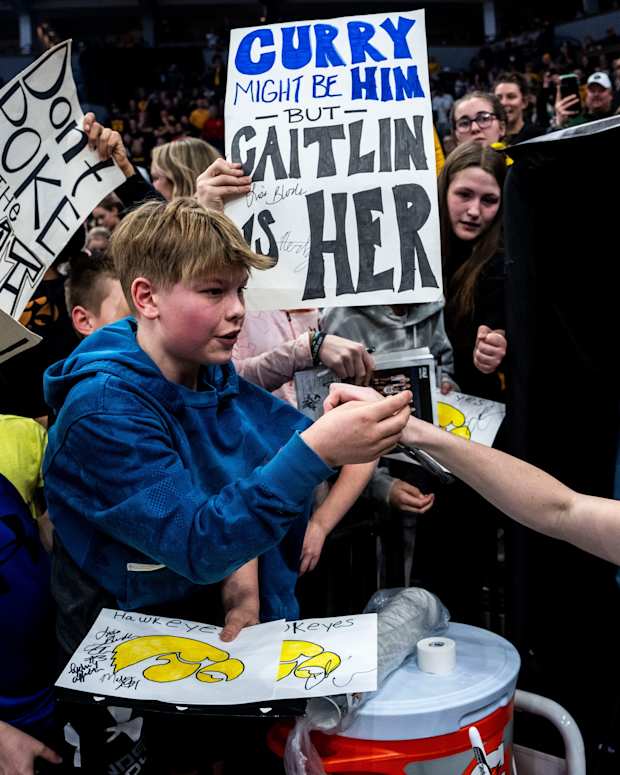Iowa guard Caitlin Clark (22) gives a fan her headband during the Big Ten Women's Basketball tournament quarterfinals at the Target Center on Friday, March 8, 2024, in Minneapolis, Minn.